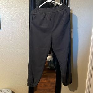 Polyester jogger pants with elastic waist band and on the bottom as well. Size M